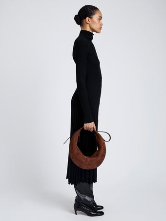 Proenza Schouler Image of model wearing Hobo Slide Bag in Soft Suede in Rust