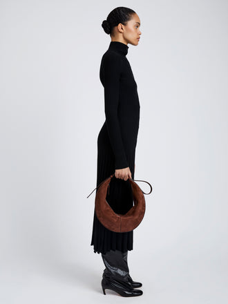 Proenza Schouler Image of model wearing Hobo Slide Bag in Soft Suede in Rust