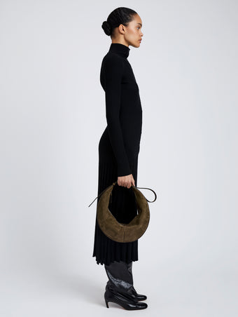 Proenza Schouler Image of model wearing Hobo Slide Bag in Soft Suede in Olive
