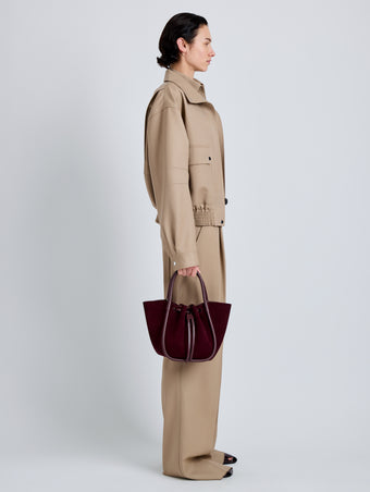 Proenza Schouler Image of model wearing Small Ruched Tote in Soft Suede in Oxblood