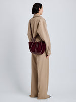 Proenza Schouler Image of model wearing Small Ruched Tote in Soft Suede in Oxblood