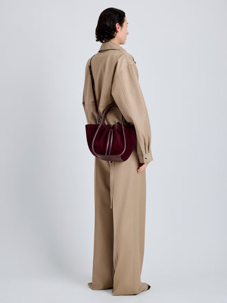 Proenza Schouler Image of model wearing Small Ruched Tote in Soft Suede in Oxblood