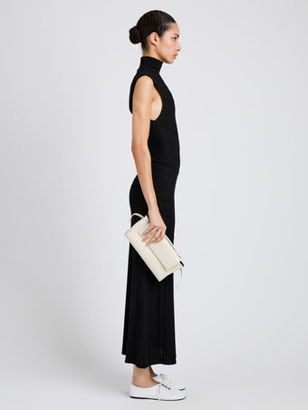 Proenza Schouler Image of model wearing Tate Clutch with Strap in Smooth Calf in Soft White