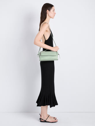 Proenza Schouler Image of model wearing Tate Clutch with Strap in Smooth Calf in Stone Blue