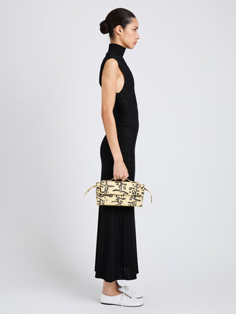 Proenza Schouler Image of model wearing Tate Clutch with Strap in Ball Python in Resin Multi