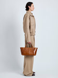 Proenza Schouler Image of model wearing East West Chelsea Tote in Soft Veg Calf in Saddle