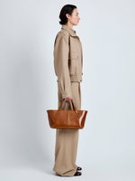Proenza Schouler Image of model wearing East West Chelsea Tote in Soft Veg Calf in Saddle