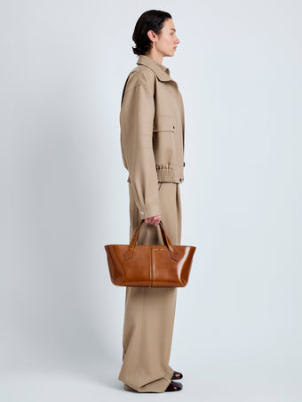 Proenza Schouler Image of model wearing East West Chelsea Tote in Soft Veg Calf in Saddle