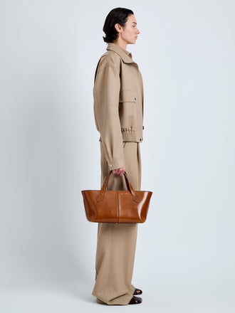 Proenza Schouler Image of model wearing East West Chelsea Tote in Soft Veg Calf in Saddle