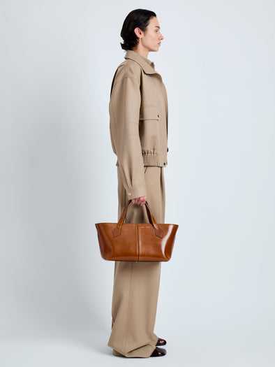 Proenza Schouler Image of model wearing East West Chelsea Tote in Soft Veg Calf in Saddle