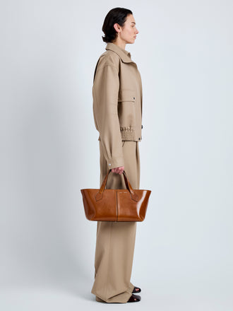 Proenza Schouler Image of model wearing East West Chelsea Tote in Soft Veg Calf in Saddle