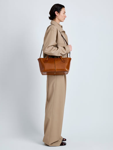 Proenza Schouler Image of model wearing East West Chelsea Tote in Soft Veg Calf in Saddle