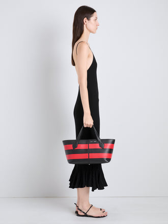 Proenza Schouler Image of model wearing Armory Clutch in Striped Nappa Plonge in TomatoBlack