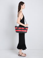 Proenza Schouler Image of model wearing Armory Clutch in Striped Nappa Plonge in TomatoBlack