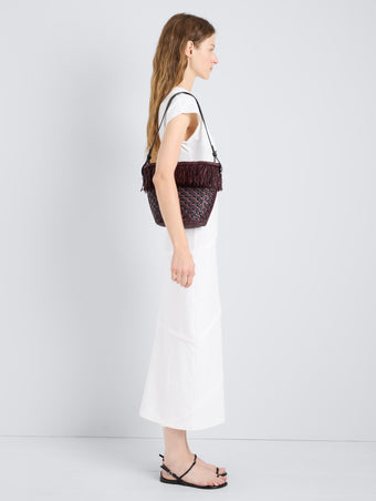 Proenza Schouler Image of model wearing the Bucket Bag in Raffia in Plum