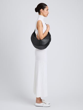 Proenza Schouler Image of model wearing Hobo Slide Bag in Pebbled Calf in black