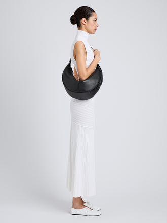 Proenza Schouler Image of model wearing Hobo Slide Bag in Pebbled Calf in black