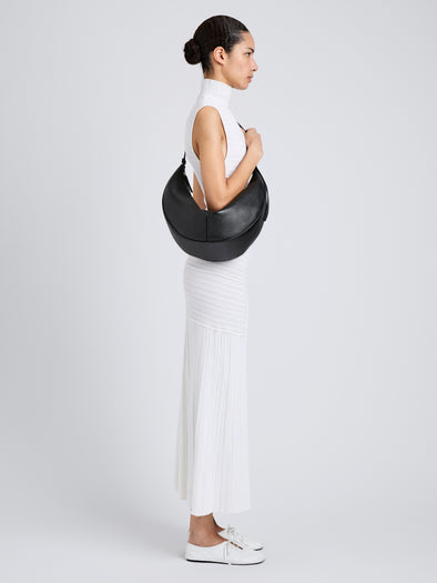 Proenza Schouler Image of model wearing Hobo Slide Bag in Pebbled Calf in black