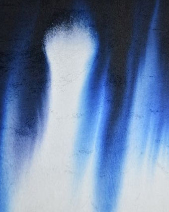 4x5 cropped image of blue dye spreading down white fabric, darkest at the top and lighter toward the bottom of the image