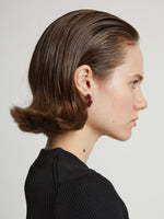 Proenza Schouler Image of model wearing mini hoop earrings in red