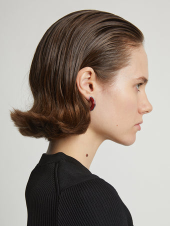 Proenza Schouler Image of model wearing mini hoop earrings in red