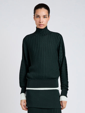 Proenza Schouler Front cropped image of model wearing Luiza Sweater in Sunburst Rib in Bottle Green 