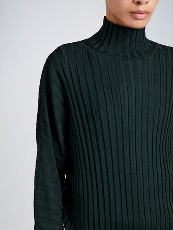 Proenza Schouler Detail image of model wearing Luiza Sweater in Sunburst Rib in Bottle Green 