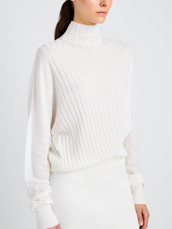 Proenza Schouler Detail image of model wearing Luiza Sweater in Sunburst Rib in White