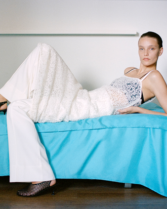 Proenza Schouler image of model laying wearing Virginie Dress in Fringe Embroidery in Off White
