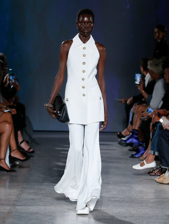 model wearing white jumpsuit