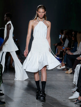 model wearing white smocked dress