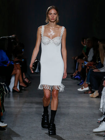 model wearing white dress