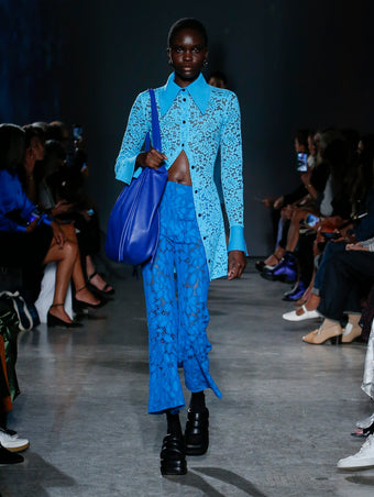 model wearing turquoise lace top and pants