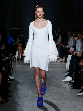 model wearing white fringe dress