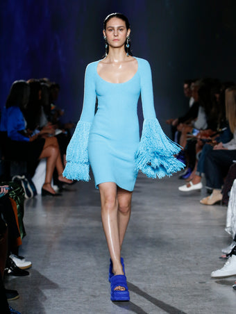 model wearing turquoise fringe dress
