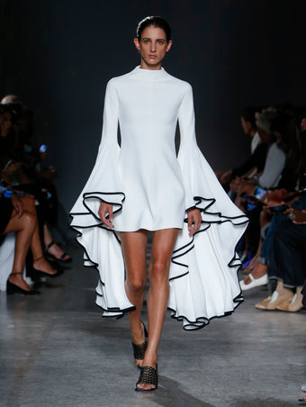 model wearing white ruffle sleeve dress