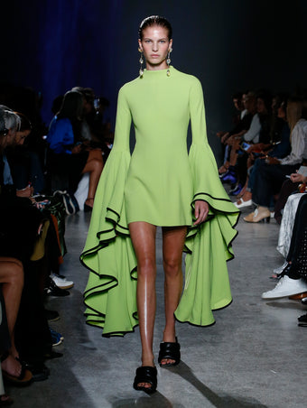 model wearing green ruffle sleeve dress
