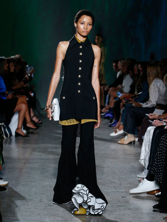 model wearing black vest and pant