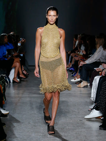Bella Hadid wearing gold dress