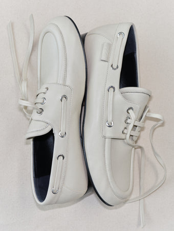 Aerial image of Deck Shoes in Nappa in Ecru on tonal beige background.