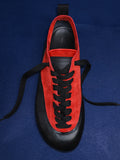 Proenza Schouler editorial image of Arcadia Sneakers in red with black laces on a blue background. 