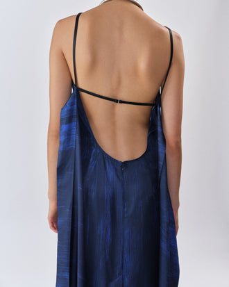 Proenza Schouler Back editorial image of model wearing Wilma Dress in Double Printed Silk Twill in Cobalt Multi with back straps untied. 