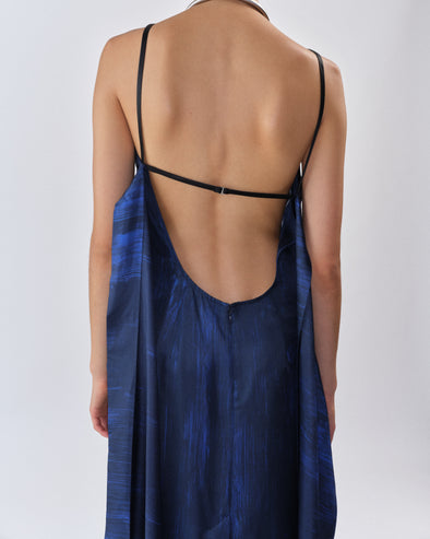 Proenza Schouler Back editorial image of model wearing Wilma Dress in Double Printed Silk Twill in Cobalt Multi with back straps untied. 