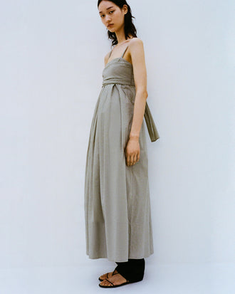 Cropped image of model standing against a white backdrop wearing the Claudine Dress in Tech Poplin in Sage