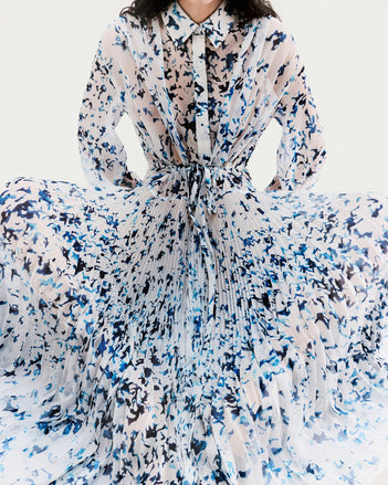 Cropped image of model standing in front of a white backdrop, wearing Jones Dress in Printed Crinkle Chiffon in Sky Blue Multi