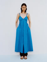 Image of model standing against a white backdrop, wearing Barker Dress in Stretch Poplin in Cyan