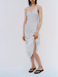 Cropped image of model standing in front of white backdrop, wearing Evelyn Dress in Crinkle Viscose in White