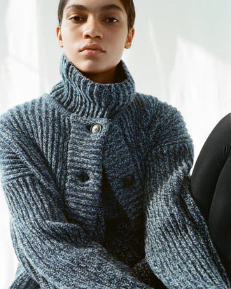 Cropped image of model wearing Azura Sweater and Ember Vest in Mouline Knits in ink melange
