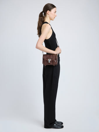 Proenza Schouler image of model wearing PS1 Mini Crossbody Bag in chestnut