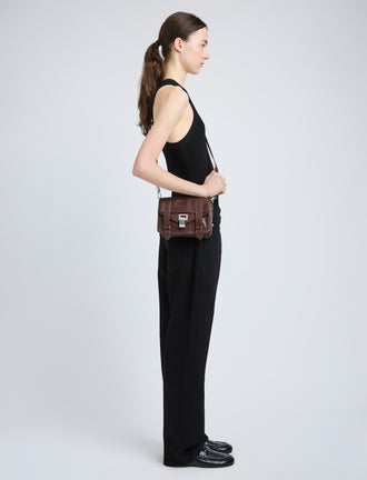 Proenza Schouler image of model wearing PS1 Mini Crossbody Bag in chestnut